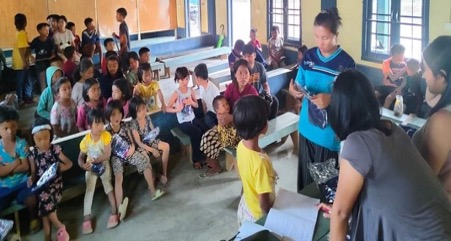 Refugee students receiving small gifts